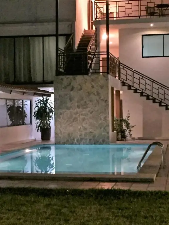 Hotel Sacré courtyard swimming pool illuminated in the evening
